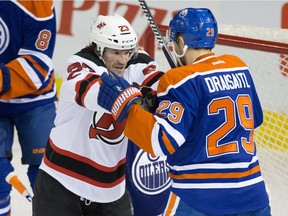 Edmonton Oilers Leon Draisaitl (29) and New Jersey Devils Bobby Farnham (23) fight during NHL action at Rexall Place in Edmonton on Nov. 20, 2015.