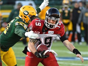 Edmonton Eskimos Odell Willis (41) can't get enough grip on Calgary Stampeders quarterback Bo Levi Mitchell (19) for a sack during the CFL Western Final at Commonwealth Stadium in Edmonton, November 22, 2015.