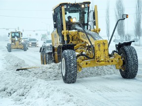 Graders on 99 St. after 10-15 cm of snow fell overnight in Edmonton, Nov. 24, 2015.