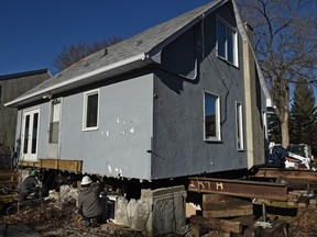Workers get ready to move this house to make way for construction of the southeast LRT line on 95th Avenue and 89th Street on Friday, Nov. 6, 2015.