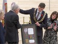 Mayor Don Iveson and the family of Pte. Cecil J. Kinross officially unveil the Victoria Cross at City Hall in Edmonton on Nov. 9, 2015.