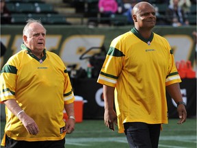 Former Edmonton Eskimos quarterbacks, alumni Tom Wilkinson, left, and Warren Moon were on hand at the special halftime ceremony where Hector Pothier and Bill Stevenson had their names added to the Eskimo Wall of Honour during a game at Commonwealth Stadium on Oct. 13, 2014.