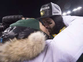 Edmonton Eskimos quarterback Mike Reilly kisses his wife Emily after his teams win over the Ottawa Redblacks of the103rd Grey Cup in Winnipeg, Man. Sunday, Nov. 29, 2015.