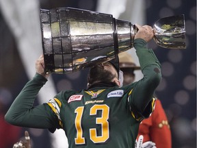 Edmonton Eskimos' quarterback Mike Reilly kisses the Grey Cup following his team's win over the Ottawa Redblacks of the 103rd Grey Cup in Winnipeg on Nov. 29, 2015.