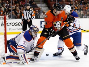 Corey Perry of the Anaheim Ducks scores as Oilers goalie Anders Nilsson and Darnell Nurse try to defend during NHL action at Honda Center on Nov. 11, 2015 in Anaheim, Calif. The Oilers won 4-3 in overtime.