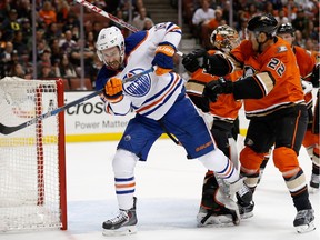 Teddy Purcell of the Edmonton Oilers battles for position with Shawn Horcoff of the Anaheim Ducks during the second period of a game at Honda Center on Nov. 11, 2015 in Anaheim, Calif.