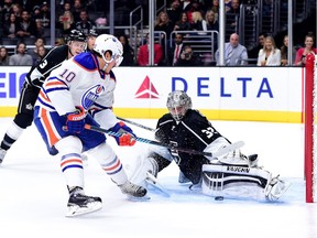 Jonathan Quick #32 of the Los Angeles Kings stops Nail Yakupov #10 of the Edmonton Oilers as Brayden McNabb #3 looks for a rebound during the first period at Staples Center on November 14, 2015 in Los Angeles.