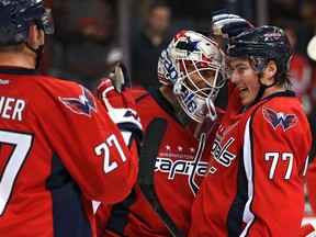 Washington Capitals goalie Braden Holtby (70) and teammate T.J. Oshie (77) celebrate after defeating the Edmonton Oilers 1-0 at the Verizon Center on Nov. 23, 2015 in Washington, D.C.