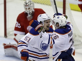Edmonton Oilers centre Anton Lander (51) and right wing Iiro Pakarinen (26) celebrate Pakarinen's goal during a game against the Detroit Red Wings, Friday, Nov. 27, 2015, in Detroit. Pakarinen is back in the Oilers lineup after missing three games due to a head injury.