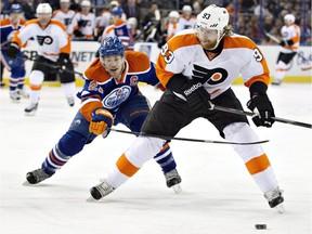 Philadelphia Flyers' Jakub Voracek (93) is cheesed by Edmonton Oilers' Andrew Ference (21) during first period NHL hockey action in Edmonton, Alta., on Saturday December 28, 2013.
