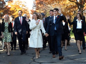Prime Minister-designate Justin Trudeau and his wife Sophie Gregoire-Trudeau walk to Rideau Hall with Trudeau's future cabinet to take part in a swearing-in ceremony in Ottawa on Nov. 4, 2015.