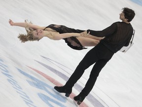 Kaitlyn Weaver, Andrew Poje, of Canada, perform their free dance to win the Cup of Russia ISU Grand Prix figure skating event in Moscow, Russia, Saturday, Nov. 21, 2015.