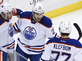 Edmonton Oilers' Leon Draisaitl (29) celebrates his goal with teammates Taylor Hall (4) and Oscar Klefbom (77) during the first period of an NHL hockey game against the Pittsburgh Penguins in Pittsburgh, Saturday, Nov. 28, 2015.