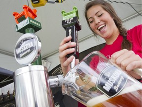 Dana Bateman of Muskoka Brewery pours a jug in Ottawa in this Aug. 17, 2012 file photo. Ontario-based Muskoka announced it will “wind down operations” in Alberta by the end of 2015.