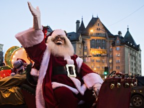 Santa Claus waves to the crowd during the Parade of Lights along Jasper Avenue in Edmonton on Saturday, Nov. 21, 2015.