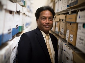 Quest PharmaTech CEO Madi Madiyalakan is photographed in their office with thousands of files from their development of a drug to treat ovarian cancer.