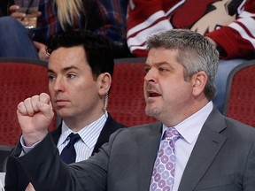 Assistant coach Jay Woodcroft and head coach Todd McLellan of the San Jose Sharks on the bench during the NHL game against the Arizona Coyotes at Gila River Arena on April 4, 2015 in Glendale, Arizona. The Coyotes defeated the Sharks 5-3.