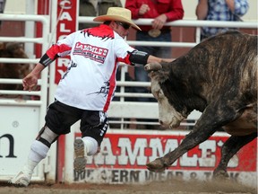Scott Byrne distracts a bull  during Calgary Stampede competition in July 2011. After two decades of staring down slobbering bulls, Byrne is set to retire at the conclusion of this week's Canadian Finals Rodeo in Edmonton.