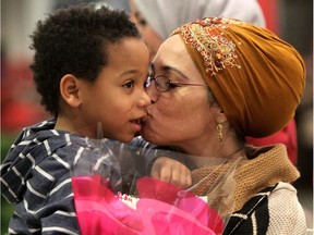 Supporters Celina Thibault and son Jakeim, 5, wait as the first group of refugees arrived at the Calgary Airport in Calgary on Monday November 23, 2015.