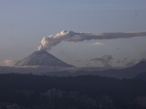 The Cotopaxi volcano spewing ash and vapor, is seen from Quito, Ecuador, Monday, Nov. 16, 2015. The Cotopaxi began showing renewed activity in April and its last major eruption was in 1877.