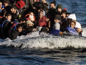 Refugees and migrants arrive on the Greek Lesbos island after crossing the Aegean Sea from Turkey on Nov. 2, 2015.