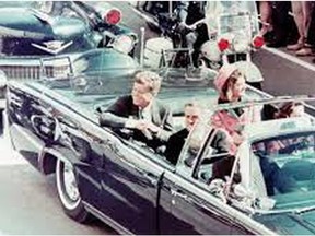 American president John F. Kennedy travels by motorcade through the streets of Dallas before he was assassinated on Nov. 22, 1963.