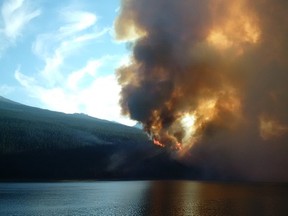 A wildfire burns Thursday July 9, 2015, in Jasper National Park. The Jasper fire guard conducts maintenance burns to prevent the spread of wildfires.