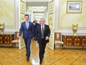 In this photo taken on Oct. 20, 2015, Syraian President Bashar Assad, left, and Russian President Vladimir Putin, arrive for their meeting in the Kremlin in Moscow.