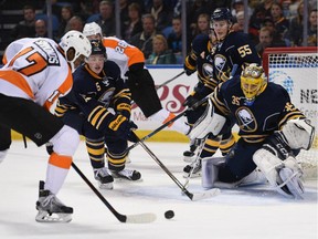 Philadelphia Flyers' Wayne Simmonds (17) shoots the puck as Buffalo Sabres' Jack Eichel (15), Rasmus Ristolainen (55), and Linus Ullmark (35) defend during the second period of an NHL game on Oct. 30, 2015 in Buffalo, N.Y.