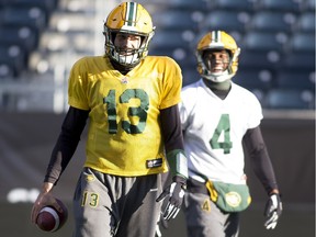 Edmonton Eskimos quarterback Mike Reilly, right, works with receiver Adarius Bowman during a practice at Winnipeg's Investors Group Field on Nov. 27, 2015. The Eskimos will play the Ottawa Redblacks in the 103rd Grey Cup on Sunday.