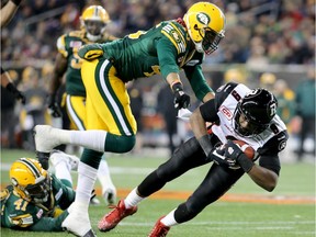 Edmonton Eskimos linebacker Dexter McCoil tackles Ottawa Redblacks receiver Ernest Jackson as the latter scores a touchdown during the Grey Cup in Winnipeg on Nov. 29, 2015.