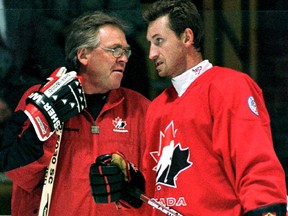 Glen Sather, left, and  Wayne Gretzky at a World Cup of Hockey practice in September 1996. Gretzky says the former Oilers coach and GM hated to lose.