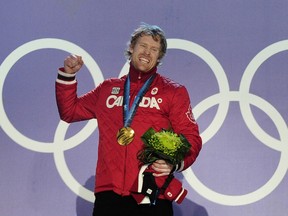 Canada's gold medalist Jon Montgomery celebrates on the podium during the medal ceremony of the men's skeleton final event of the Vancouver Winter Olympics in Whistler on February 20, 2010.