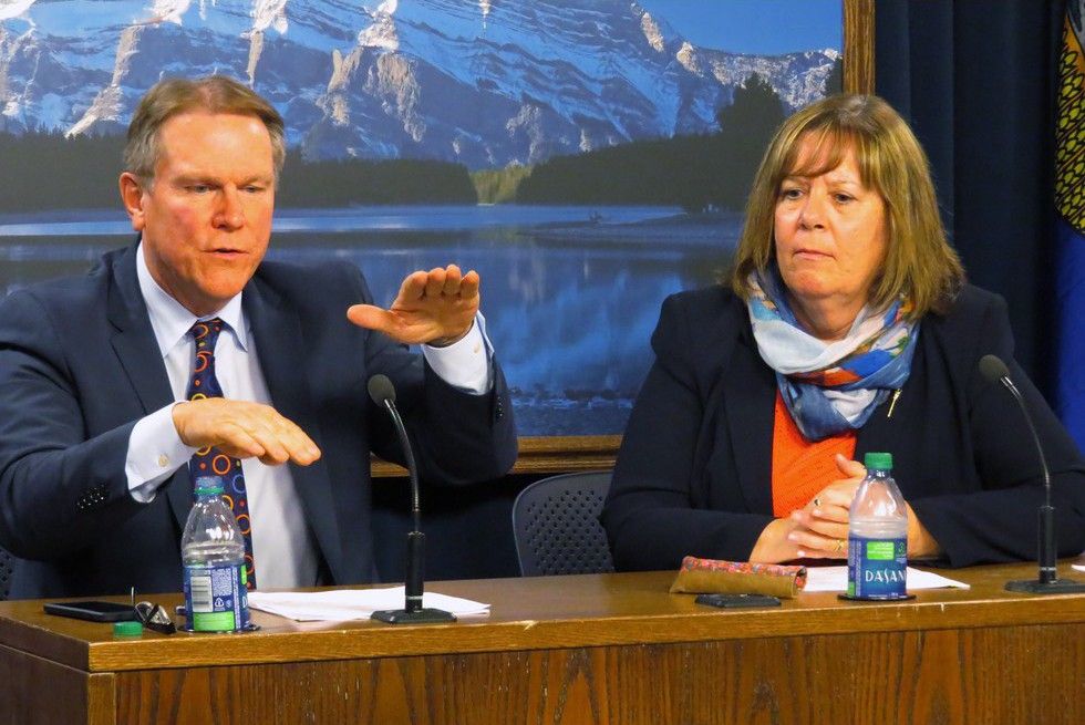 Alberta Energy Minister Marg McCuaig-Boyd, right, and Dave Mowat, the president and CEO of ATB Financial, take questions in the legislature media room after McCuaig-Boyd announces Mowat will head up a review of Alberta's oil and gas royalty structure in Edmonton, Friday, June 26, 2015. The NDP government says it wants to make sure Albertans are getting a fair return on profits from the the oil and gas sector.