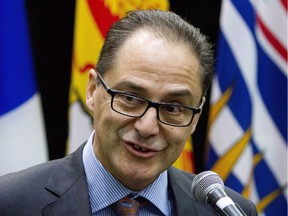Alberta Finance Minister Joe Ceci talks to reporters before the start of a meeting with Federal Finance Minister Bill Morneau and his provincial and territorial counterparts, in Ottawa, on Monday, Dec. 21, 2015.