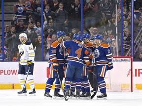 Buffalo Sabres' Cody Franson (46) skates past as the Edmonton Oilers celebrate a goal during first period NHL action in Edmonton, Alta., on Sunday, December 6, 2015.