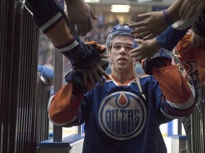 Edmonton Oilers' Connor McDavid leaves the ice after being name the first star of the game as the Oilers defeated the Minnesota Wild in an NHL pre-season hockey game in Saskatoon on Sept. 26, 2015. McDavid is set to return to the Edmonton Oilers lineup in early 2016 but has already made an impact on a city starved for a team that doesn't have to contend but should at least compete.