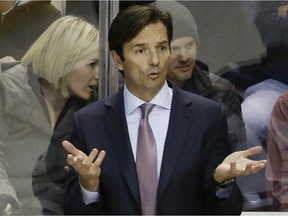 Edmonton Oilers head coach Dallas Eakins asks an official why a call was made in the third period of an NHL hockey game against the Nashville Predators on Nov. 27, 2014, in Nashville, Tenn. The Predators won 1-0 in overtime.