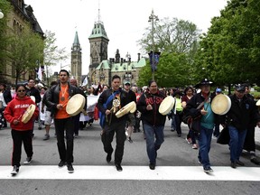 Drummers pass Parliament Hill as they lead the Walk for Reconciliation, part of the closing events of the Truth and Reconciliation Commission on Sunday, May 31, 2015 in Ottawa. The publication of the results of the commission was one of the year's most significant publishing events, says Books columinst Michael Hingston.
