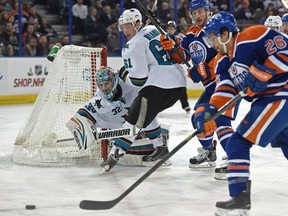 Edmonton Oilers centre Mark Arcobello chases the puck near San Jose Sharks goalie Alex Stalock during NHL action at Rexall Place in Edmonton on Dec. 7, 2014.