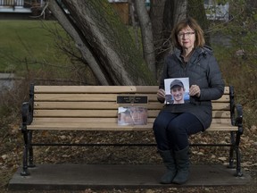 Lorna Thomas sits on a memorial bench in Riverdale with a picture of her son Alex Thomas-Haug (1987-2012).