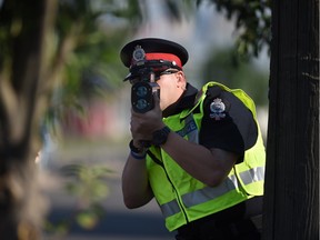 Fire photo of Edmonton police Const. Andrew Kirby uses laser radar at a speed trap set up on 99th Street in Edmonton.