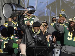 Edmonton Eskimos general manager Ed Hervey hoists the Grey Cup in front of thousands of fans who rallied at Churchill Square in downtown Edmonton on Dec. 1, 2015, to celebrate the team's 14th CFL championship.