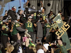 Edmonton Eskimos quarterback Mike Reilly hoists the Grey Cup in front of thousands of fans during a celebration rally at Churchill Square in downtown Edmonton on Dec. 1, 2015.