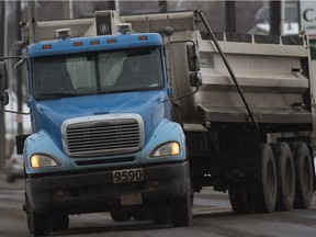 A gravel truck rumbles along Stadium Road in Edmonton on Wednesday Dec. 16, 2015.