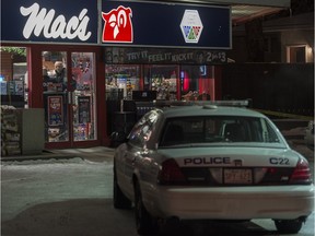 Police investigate the scene of a homicide at a Mac's convenience store at 108th Street and 61st Avenue in Edmonton on Friday, Dec. 18, 2015.