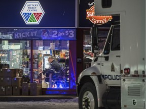 Police investigate the scene of a murder at a Mac's Store at 108 Street at 61 Avenue in the early morning hours in Edmonton on Friday Dec. 18, 2015.