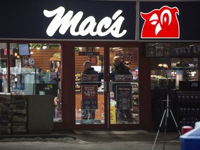 Police investigate the scene of a murder at a Mac's Store at 108 Street at 61 Avenue in the early morning hours in Edmonton on Friday Dec. 18, 2015.