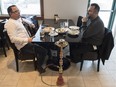 Sam George and Joe Davis enjoy a meal and a  Sheisha pipe at the Parkallen Kitchen and Bar in west Edmonton.