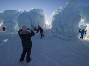 Visitors explore an ice castle on opening day in Hawrelak Park in Edmonton on Wednesday Dec. 30.